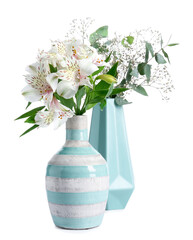 Beautiful vases with flowers on white background