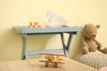 Toy airplane on table in kindergarten