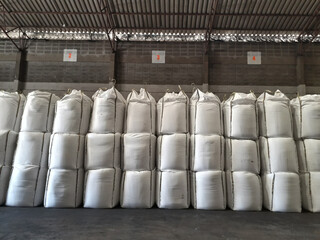 Large jumbo hemp sack White, packed with chemical fertilizer, rice, sugar, placed on a wooden pallet waiting to be delivered to the customer
