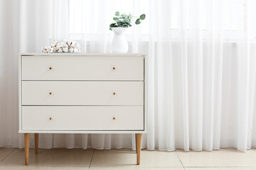 Modern chest of drawers in interior of room