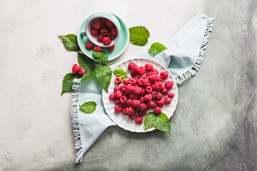 Tasty ripe raspberries on light background