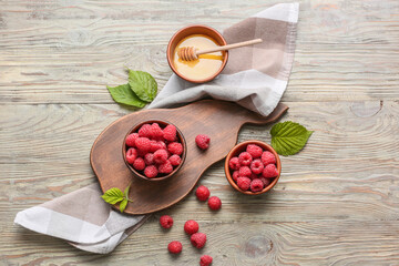 Tasty ripe raspberries with honey on table © Pixel-Shot