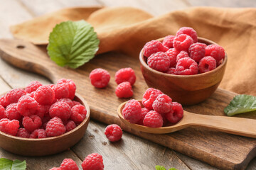 Tasty ripe raspberries on table