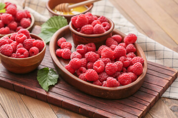 Tasty ripe raspberries on table