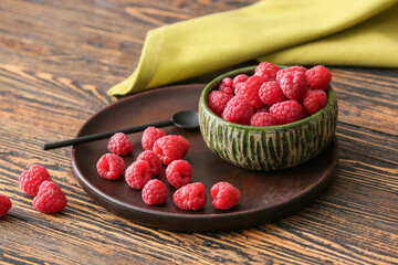 Tasty ripe raspberries on table