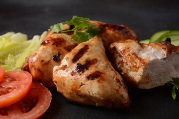 Grilled chicken breast  with cherry tomatoes, herbs, olive oil, pepper,sliced cucumber and herbs.