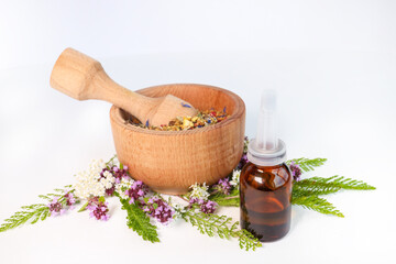 natural oils in a glass bottle on a white background. The concept of pure organic ingredients in cosmetology. The atmosphere of harmony, relaxation, spa. Close the macro. Healthy lifestyle.