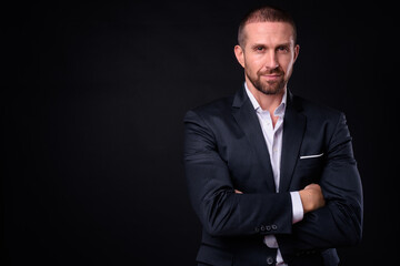 Portrait of handsome bearded businessman in suit