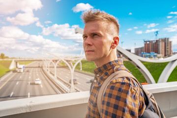 A young blond man in shirt looking at the road section of St. Petersburg Western high-speed...