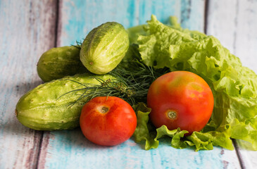 Fresh vegetables on a table, tomatoes cucumber salad dill