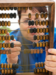 Bookkeeper with wooden abacus.