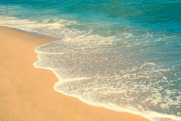 The beach and sea surface with Deep Blue sea clear sky clouds. Landscape with Ocean small waves water reflection copy space for text. Illustration for tourism, website or ad. Andaman sea, Thailand.