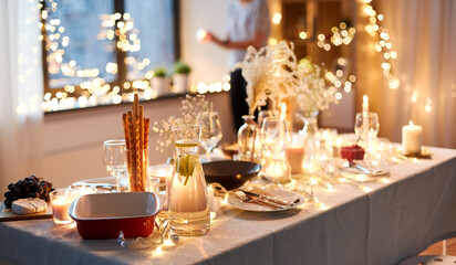 eating, holiday and celebration concept - dinner party table serving at home