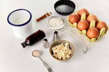 food, culinary and recipe concept - cooking ingredients and kitchen tools for baking on table
