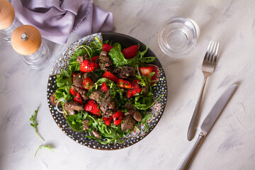 Chicken liver salad with strawberries and arugula. Liver and berries salad. overhead horizontal photo