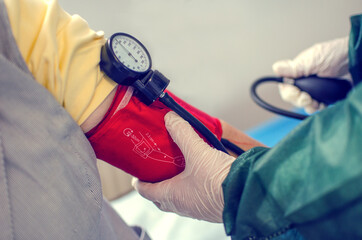 Doctor Taking the Blood Pressure of a Woman
