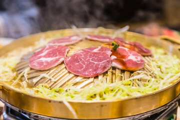 Grill food in a brass pan