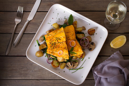 Cod Fish Fillets With Potatoes, Mushrooms And Spinach On White Plate. Overhead Horizontal Photo