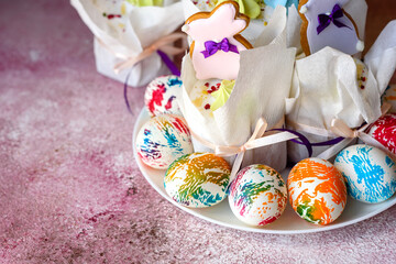 Easter bright multicolored eggs with Easter pies on a white ceramic plate