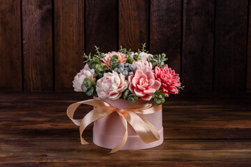 Bouquet of beautiful bright rose flowers in a gift cylindrical cardboard box