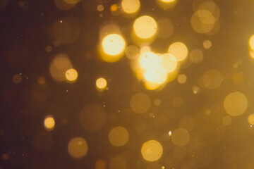 Obraz premium Dark Abstract Gold bokeh sparkle on black background