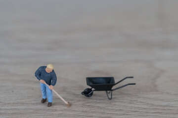 Miniature people cleaning the floor