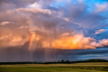 Late evening rain cloud with rainbow