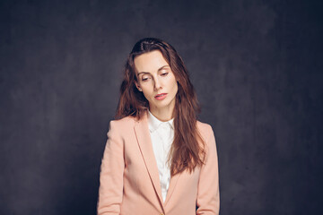 Depressed adult caucasian woman on dark background