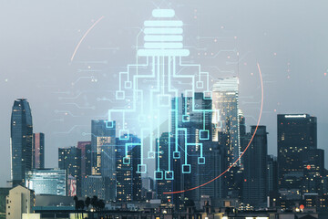 Double exposure of virtual creative light bulb hologram with chip on Los Angeles city skyscrapers background, idea and brainstorming concept