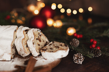 Traditional German Christmas cake - Cranberry Stollen, Christmas tree, ornaments, and candles.