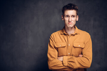 Upset young caucasian man on dark background