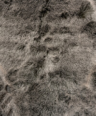 Graues weiches und flauschiges Schaffell als Hintergrund