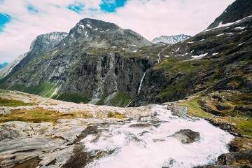 Trollstigen, Andalsnes, Norway. Stigfossen Waterfall Near Famous Mountain Road Trollstigen. Norwegian Landmark And Popular Destination. Norwegian County Road 63 In Sunny Summer Day