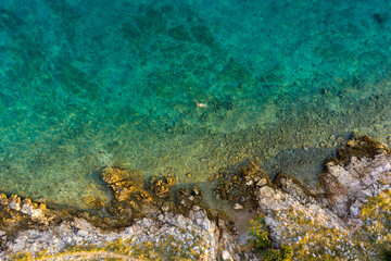 Aerial view of a naked girl swimming in sea