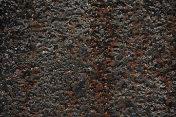 A sheet of metal with traces of rust and dents on the surface