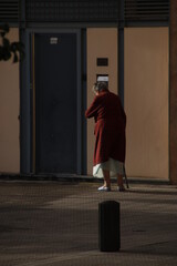 Ageing woman walking in the street