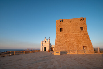 Torre di Nao and church of the Madonna di Capo Colonna at sunset on the Ionian Sea. Capo Rizzuto,...