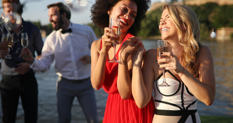 Obraz premium Group of friends having fun and celebrating group gathering outdoor