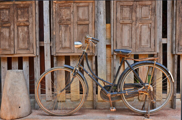 Fototapeta premium Old woman bicycle beside the windows of storage warehouse1