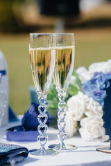 Beautiful decorated holiday glasses with champagne close-up. Holiday glasses