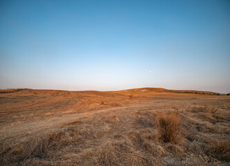 dry fields clay hills called Sciolle at sunset in the province of Crotone, Calabria, Italy.