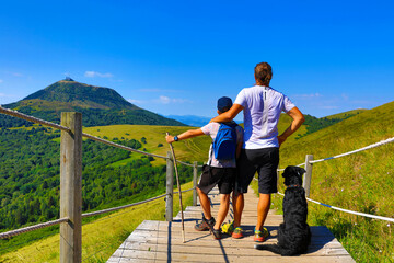 father and son hiking together- Auvergne in France, Puy de Dome