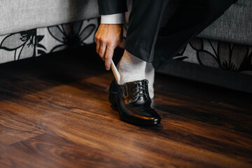 A stylish man wears classic shoes close-up. Fashion