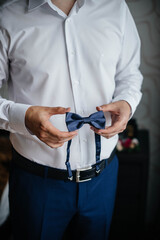 Stylish man holding a butterfly close-up. Fashion