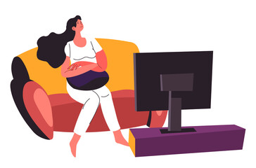 Woman watching television sitting on couch at home