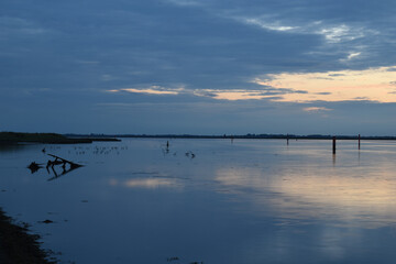 Long exposure golden sunset over Breydon Water, a stretch of the River Yare at Great Yarmouth, Norfolk, UK