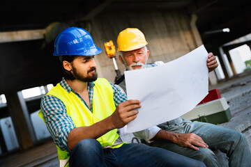 Fototapeta premium Team of construction engineers, architects working on building site