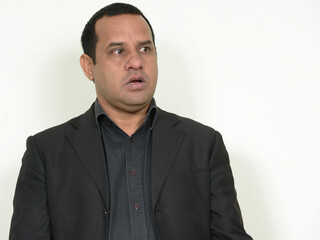 Portrait of overweight Indian businessman in suit