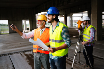 Architect and construction engineer or surveyor discussion plans and blueprints