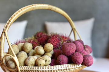 Assorted fruites on bamboo basket (banana, lychee, rambutan and  longkong) fruit health food. or a gift basket for important people